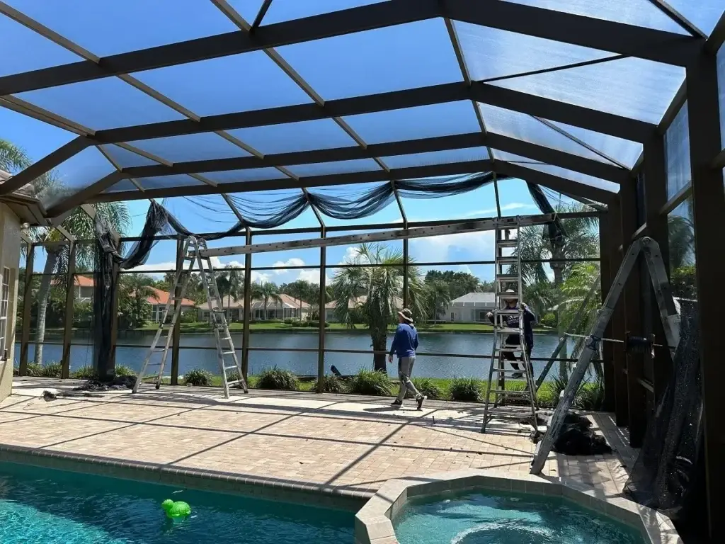 Workers assembling poolside screen structure