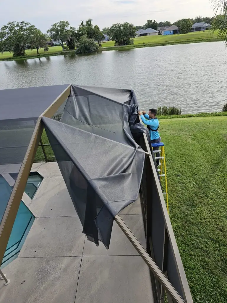 Rolls of new screen on a pool cage roof during rescreening