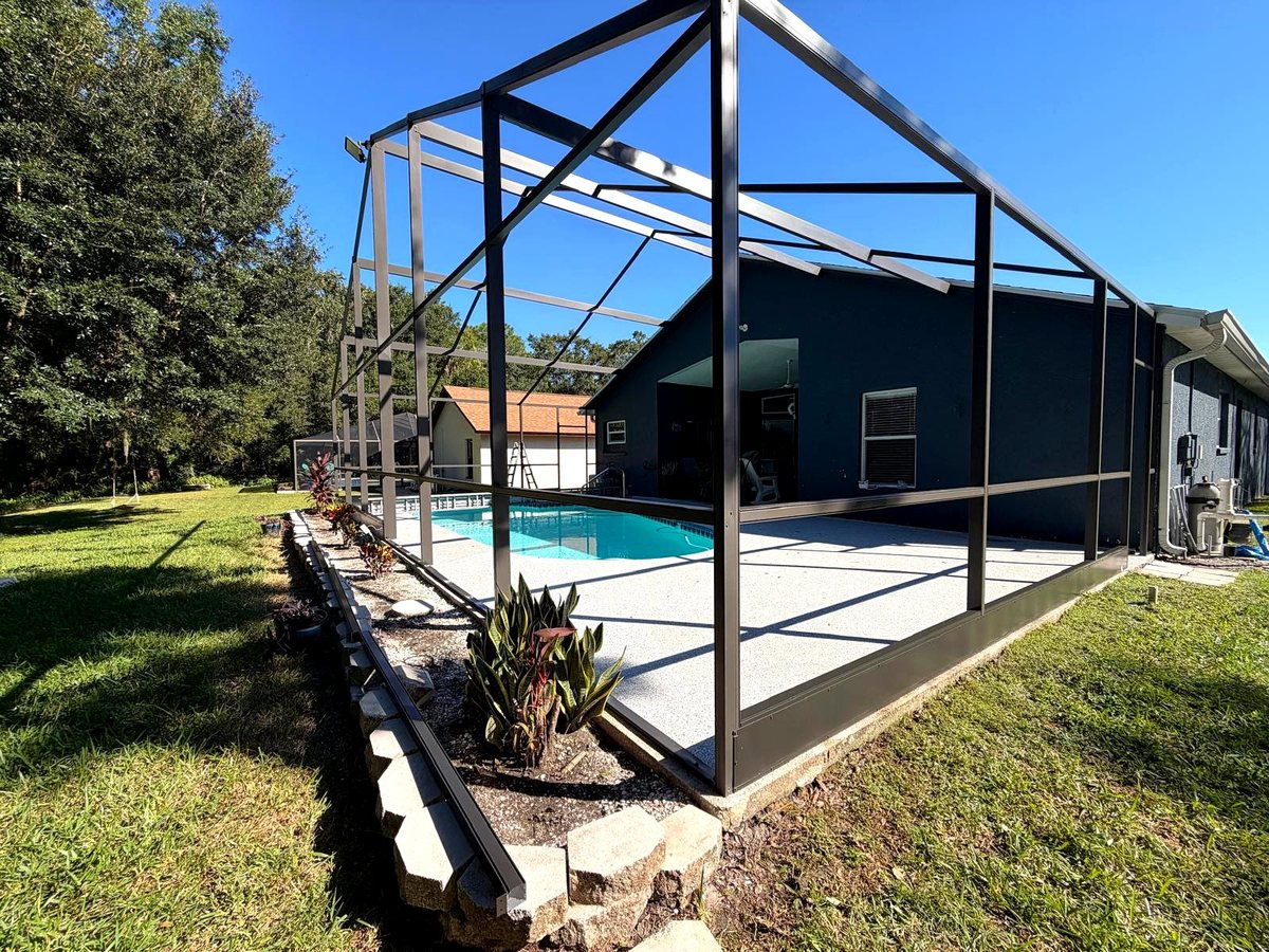 Black aluminum pool cage screen enclosure exterior after painting and rescreening in Florida