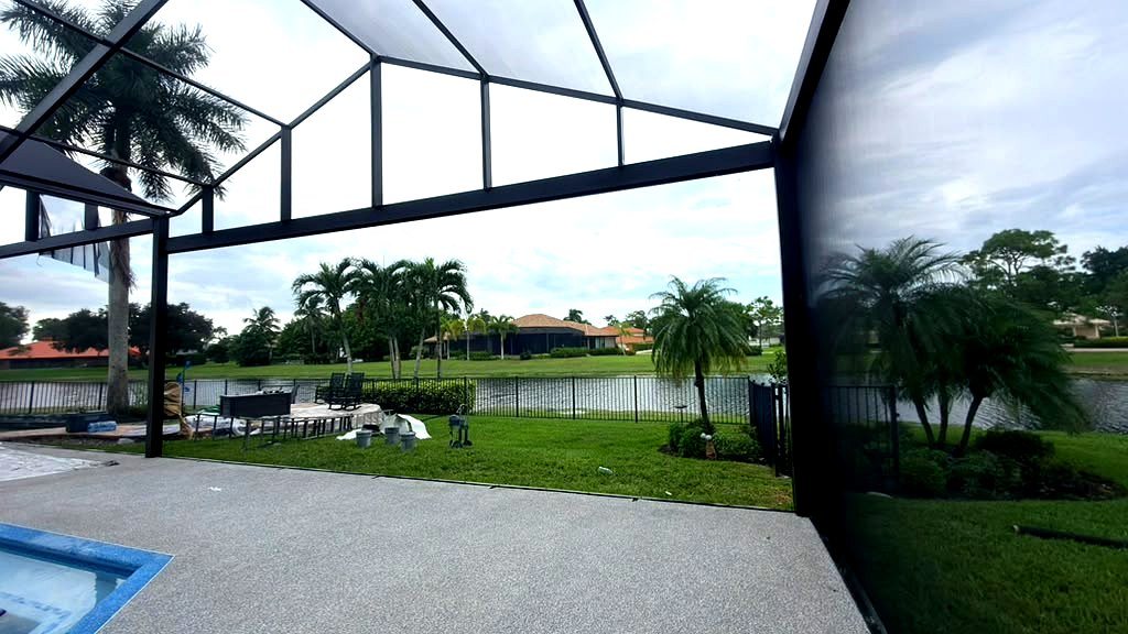 Pool cage with clear-view panoramic screen overlooking a lake, restored by ABC Pool Cage Painting